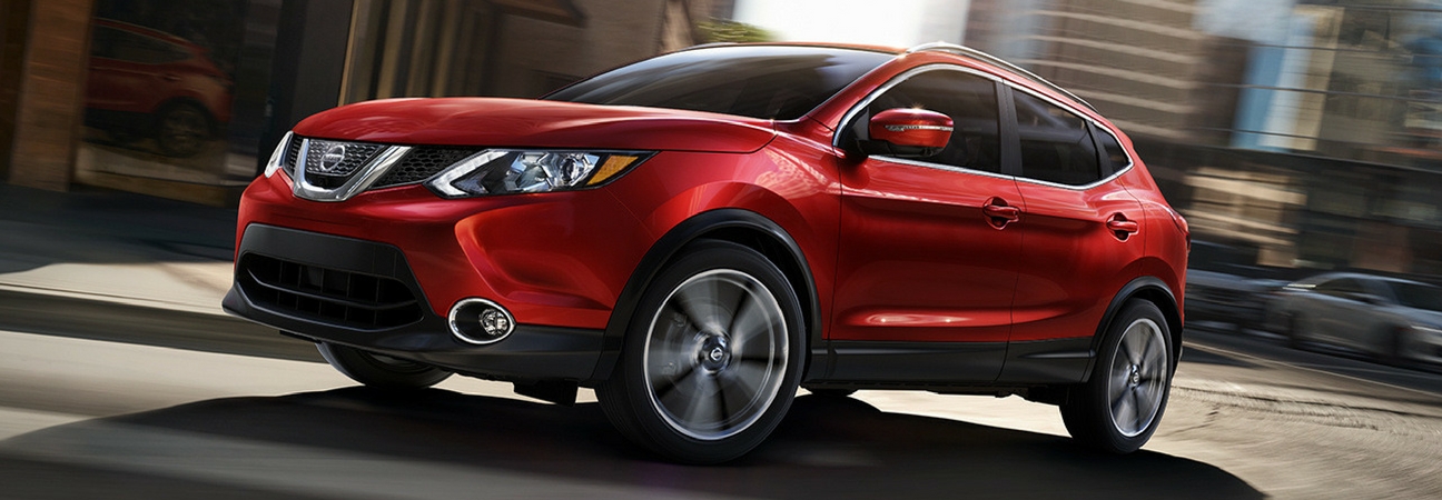 A red 2017 Nissan Rogue Sport featured in a blog about Nissan SUVs