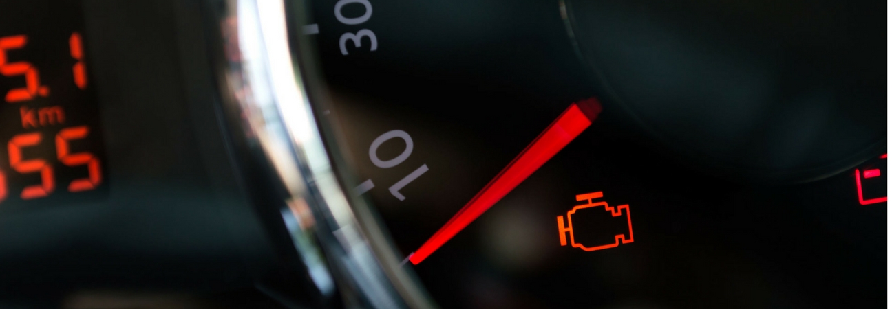 A close up of a car's gauge with a check engine light on