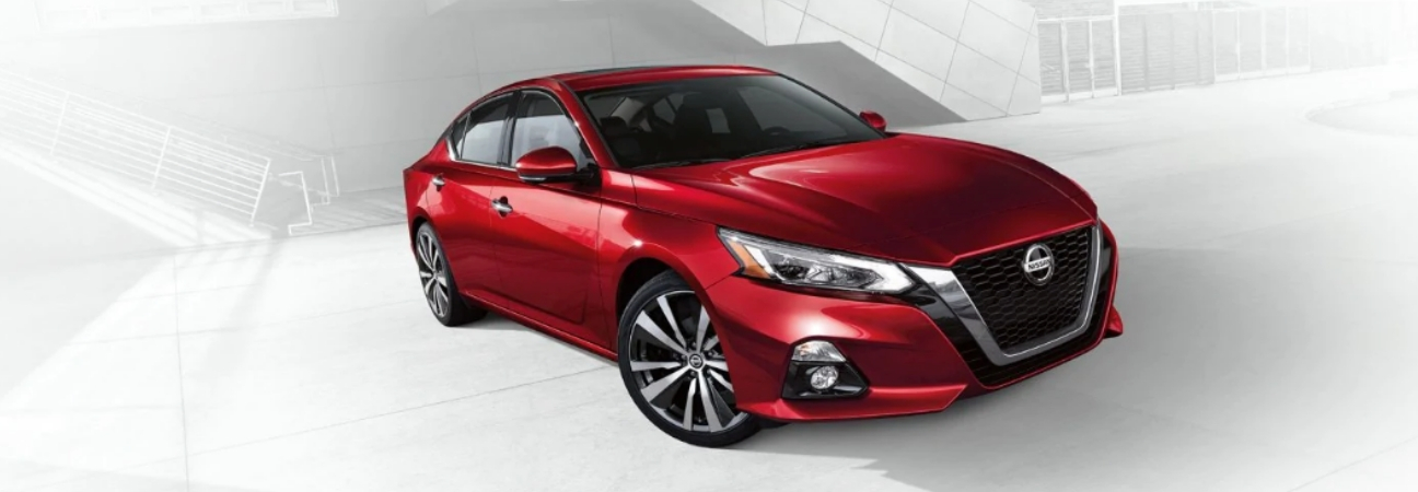 Red 2019 Nissan Altima in white industrial foreground